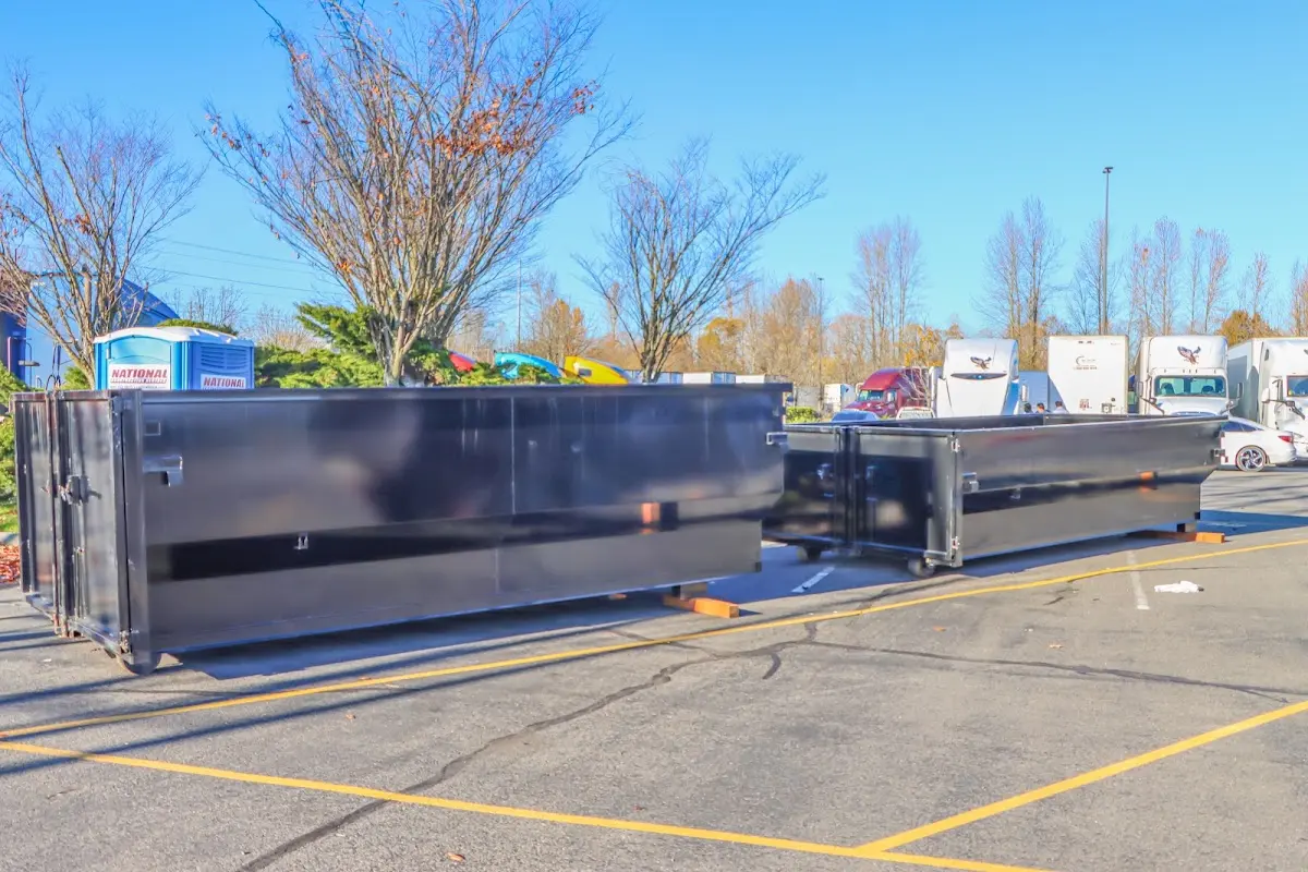 Professional dumpster rental service with roll-off container on residential driveway in Americus